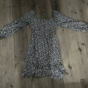 Short blue floral dress with square neckline.